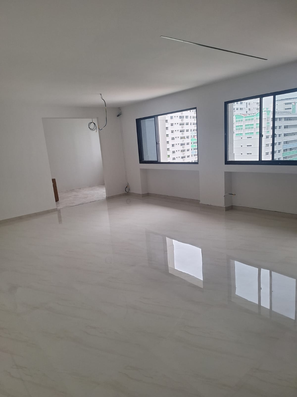 Mirror-like marble gum grout floor finish across a spacious room