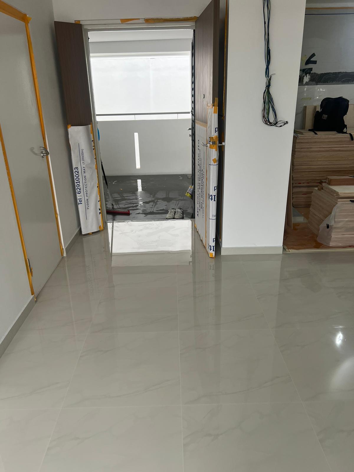 Marble gum grouting work in progress in a Singapore home hallway