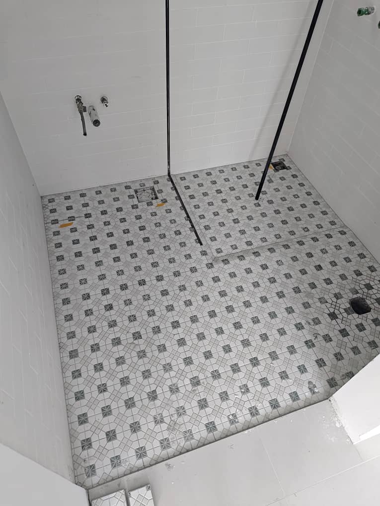 Same bathroom floor after epoxy grouting with clean, even lines