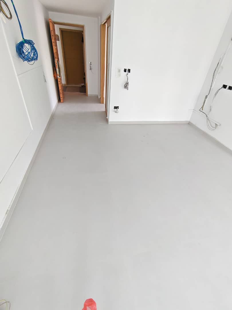 Completed epoxy grouting job across a finished room floor